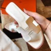 HERMES ORAN SLIDE SANDALS IN BETON EPSOM CALFSKIN - HMSD065
