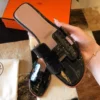 HERMES ORAN SLIDE SANDALS IN BLACK SHINY NILOTICUS CROCODILE SKIN - HMSD046
