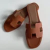 HERMES ORAN SLIDE SANDALS IN GOLD CLEMENCE LEATHER - HMSD105
